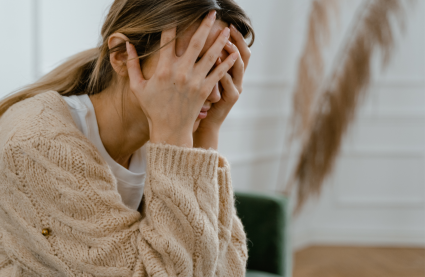 Woman with hands over face